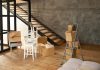 Cómo hacer el cambio de uso de local a vivienda y qué ha cambiado en Madrid Local diáfano con suelo de madera y escalera, convertido en vivienda durante la mudanza