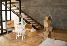 Cómo hacer el cambio de uso de local a vivienda y qué ha cambiado en Madrid Local diáfano con suelo de madera y escalera, convertido en vivienda durante la mudanza